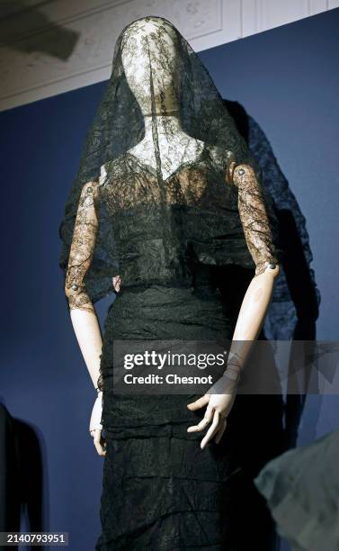 Creation by designer Cristobal Balenciaga, Haute Couture Collection, Fall-Winter 1956 short evening dress in black lace is displayed during "Un...