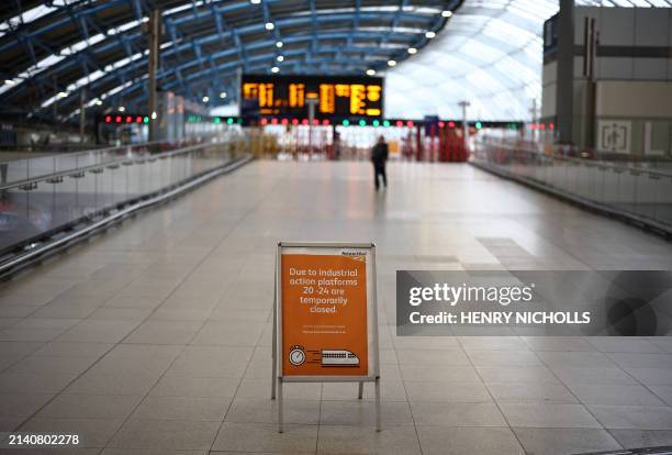 Empty platforms are pictured during the morning rush hour at Waterloo Station in London on April 8 as train drivers strike over pay. Rail services...
