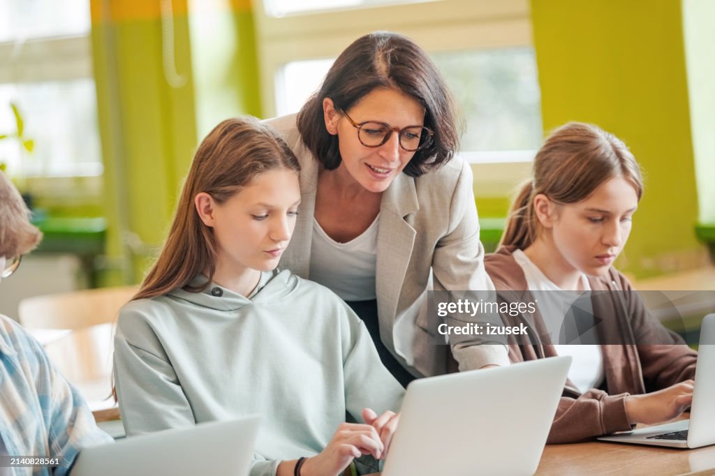 High school students using laptops in the classroom