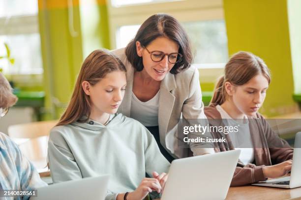 high school students using laptops in the classroom - high school student stock pictures, royalty-free photos & images