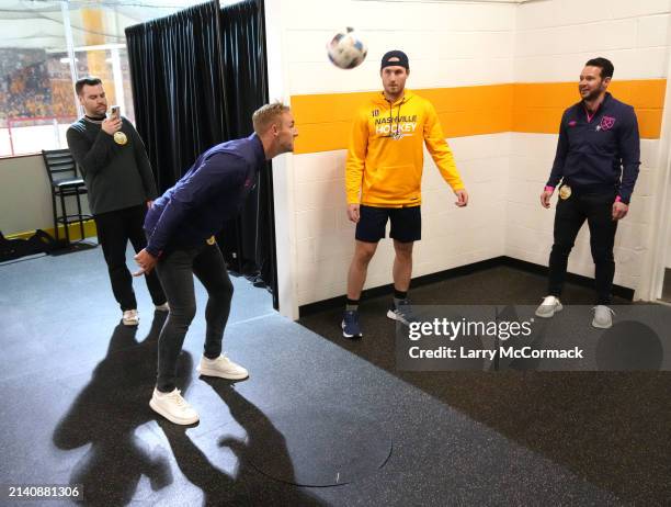 Premier League players Matt Jarvis, Jack Collison and Daniel Sturrridge do a warm up exercise with the Nashville Predators before the game at...