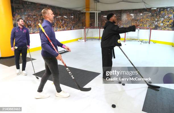 Premier League players Matt Jarvis, Jack Collison and Daniel Sturrridge practice their stick work before the Nashville Predators game at Bridgestone...