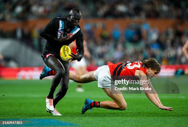 Harrison Jones of the Bombers competes with Aliir Aliir of the Power during the round four AFL match between Port Adelaide Power and Essendon Bombers...