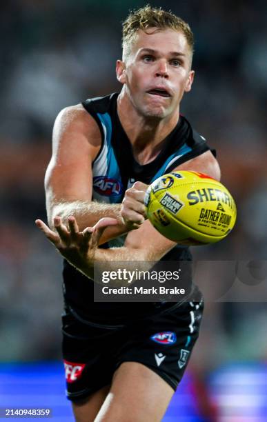 Dan Houston of the Power handballs during the round four AFL match between Port Adelaide Power and Essendon Bombers at Adelaide Oval, on April 05 in...
