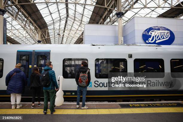 Commuters wait to board a South Western Railway train, during a train drivers strike, at Waterloo railway station, in London, UK, on Monday, April 8,...