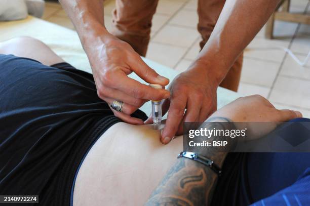 Liberal country nurse at the home of a patient for a subcutaneous injection of Lovenox for the prevention of phlebitis.