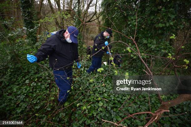 Specialist search officers comb the woods for evidence near where human remains have been discovered on April 05, 2024 in Salford, England. A murder...