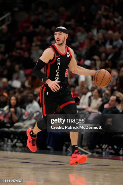 Alex Caruso of the Chicago Bulls dribbles the ball during the second half against the Atlanta Hawks at the United Center on April 01, 2024 in...