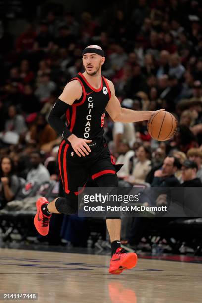 Alex Caruso of the Chicago Bulls dribbles the ball during the second half against the Atlanta Hawks at the United Center on April 01, 2024 in...