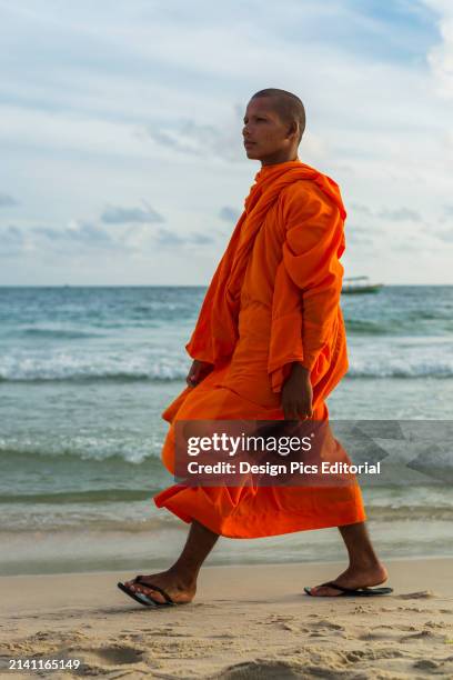 Monk Walks on The Sand of Serendipity Beach. Sihanoukville, Cambodia.