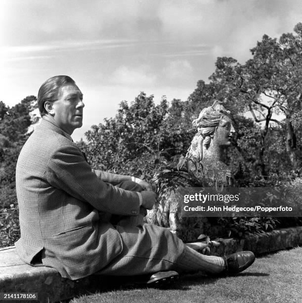 British industrialist and horticulturalist Charles McLaren, 3rd Baron Aberconway seated in the grounds of Bodnant Hall and Gardens near the village...