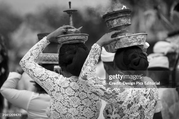 Young Women At A Religious Ceremony Carrying A Smoking Offering on Her Head. Bali, Indonesia.