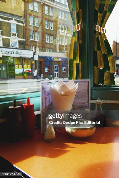 Restaurant Table Set With Condiments and A Menu, Shoreditch. London, England.