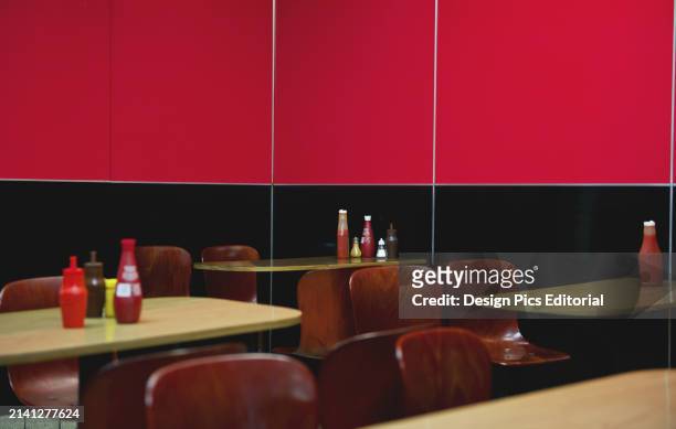 Seating In A Restaurant With A Wall Half Black and Half Bright Red. London, England.