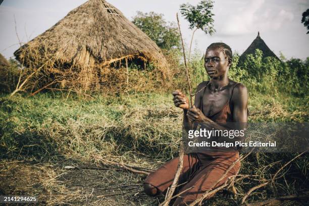 Nuer Woman Preparing Firewood, Near Gambella, Western Ethiopia. Ethiopia.