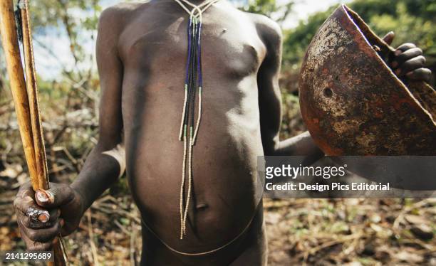 Suri Tribe Cattle Herder With Bowl For Collecting Cattle Blood, Omo Region, Southwest Ethiopia. Kibish, Ethiopia.