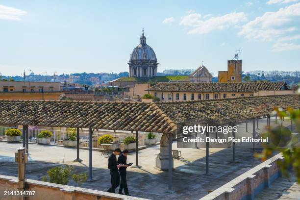 Priests Praying on A Rooftop. Rome, Lazio, Italy.