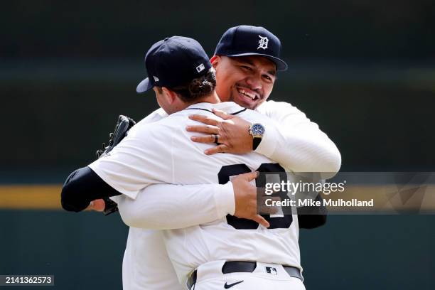 Penei Sewell of the Detroit Lions hugs Jason Foley of the Detroit Tigers after throwing the first pitch before a game between the Tigers and the...