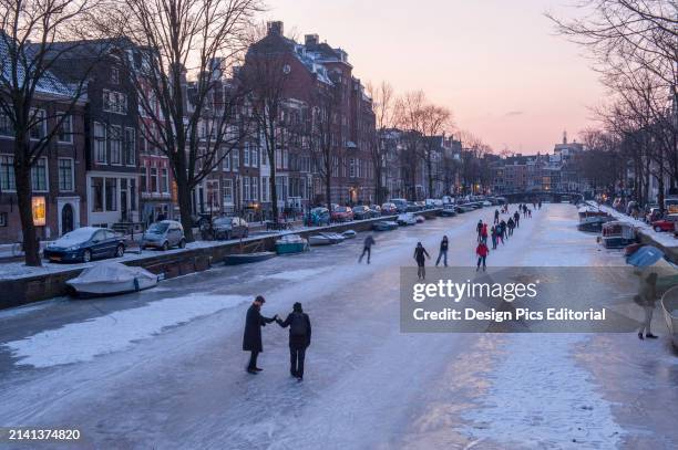 Ice skating on the canals. Amsterdam, Netherlands.