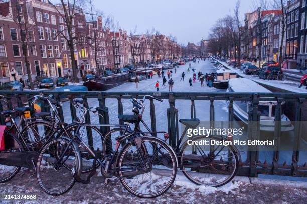 Ice skating on the canals. Amsterdam, Netherlands.