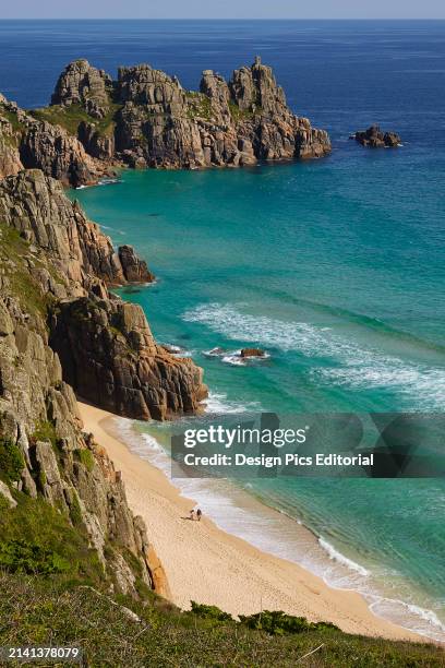 View from the cliffs at Treen across Pen-y-Vaunder beach to Logan Rock, near Penzance Cornwall, Great Britain. Cornwall, England.