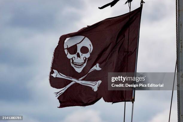 Weathered and worn skull and crossbones pirate flag. England.