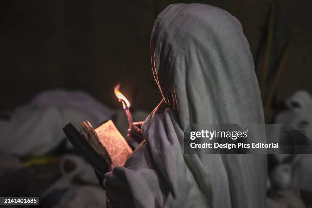 Ethiopian Pilgrim With Bible and Candle. Lalibela, Ethiopia.