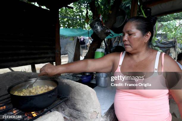 Woman cooks at the Comunidad Cerro Bita on April 05, 2024 in Puerto Carreño, Colombia. Puerto Carreño is the departmental capital city, and a...