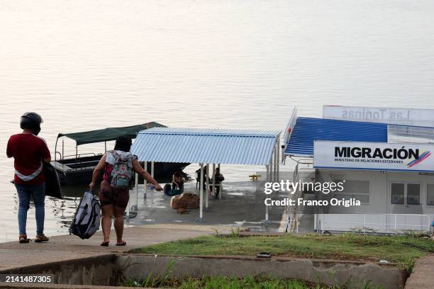 People walk towards the migration office at the port on the Orinoco River on April 05, 2024 in Puerto Carreño, Colombia. Puerto Carreño is the...