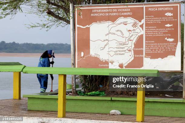 Woman cleans the flowerbeds at the port on the Orinoco River on April 05, 2024 in Puerto Carreño, Colombia. Puerto Carreño is the departmental...