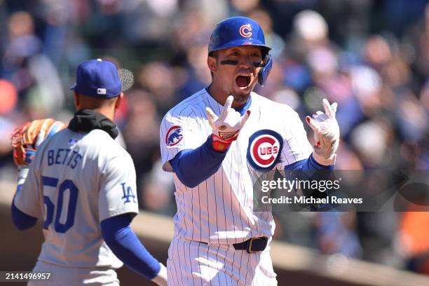 Seiya Suzuki of the Chicago Cubs celebrates after hitting a two-RBI double during the second inning against the Los Angeles Dodgers at Wrigley Field...