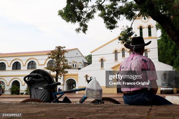 Man sits in front of Puerto Carreño's cathedral 'Nuestra Señora del Carmen' on April 05, 2024 in Puerto Carreño, Colombia. Puerto Carreño is the...
