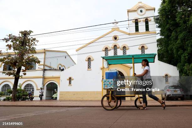 Street vendor passes by Puerto Carreño's cathedral 'Nuestra Señora del Carmen' on April 05, 2024 in Puerto Carreño, Colombia. Puerto Carreño is the...