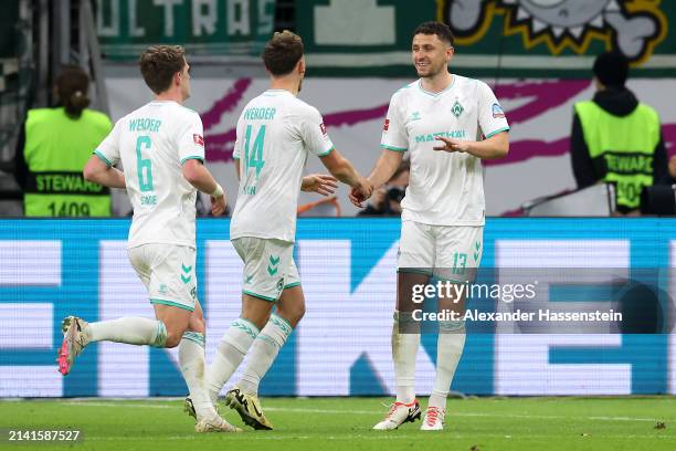 Milos Veljkovic of SV Werder Bremen celebrates scoring his team's first goal with teammates Jens Stage and Senne Lynen during the Bundesliga match...