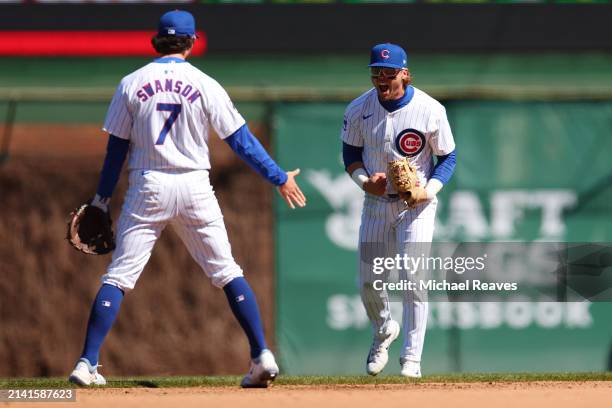 Nico Hoerner of the Chicago Cubs celebrates a out with Dansby Swanson against the Los Angeles Dodgers during the fourth inning at Wrigley Field on...