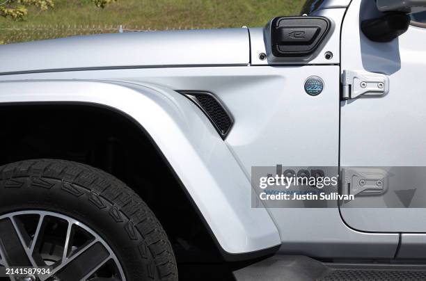 View of a charging point on a Jeep Wrangler 4Xe plug-in hybrid that is displayed on the sales lot at Hilltop Chrysler Jeep Dodge Ram on April 05,...
