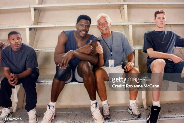 Muggsy Bogues, Patrick Ewing, Austin McCann and Shawn Bradley sit on the bleachers on the set of "Space Jam" at John Marshhall High School in 1995 in...