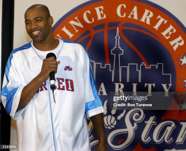 Vince Carter of the Toronto Raptors speaks to children during a practice session for the Vince Carter Charity All Star Game in Toronto, Ontario. NOTE...