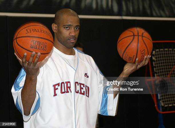 Vince Carter of the Toronto Raptors speaks to children during a practice session for the Vince Carter Charity All Star Game in Toronto, Ontario. NOTE...