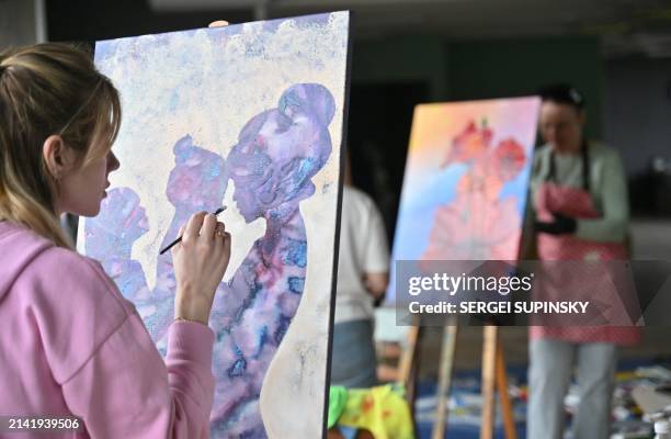 Woman paints during an art therapy workshop titled "Live" and organised by the "Modern Ukraine" Charitable Foundation for women who lost their...