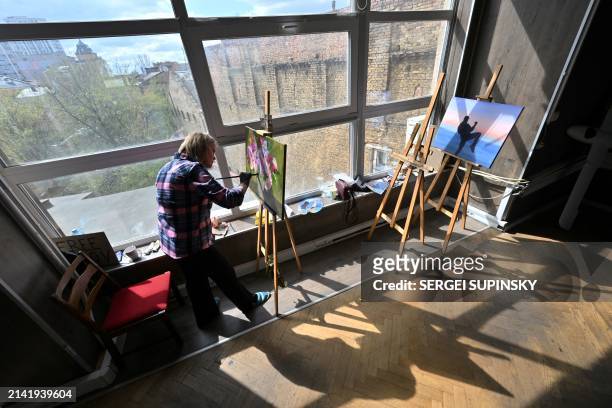 Woman paints during an art therapy workshop titled "Live" and organised by the "Modern Ukraine" Charitable Foundation for women who lost their...