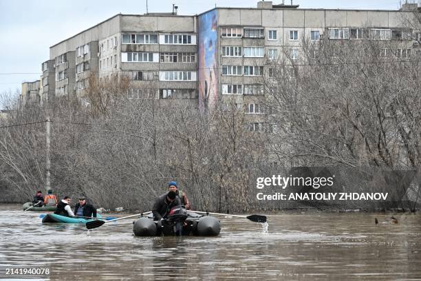 Picture taken on April 8, 2024 shows rescuers evacuating residents from the flooded part of the city of Orsk, Russia's Orenburg region, southeast of...