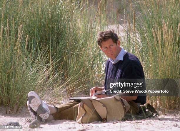 Prince Charles painting with watercolours on the beach during a holiday to Scotland, in August 1989.