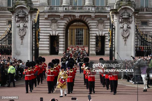 Members of France's Gendarmerie Garde Republicaine march behind members of the British Army's Band of the Grenadier Guards after taking part in a...