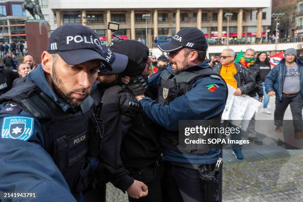 Police officers arrest an anti-fascist sympathizer during an anti-immigration protest. Around two hundred far-right protesters demonstrated in Porto...