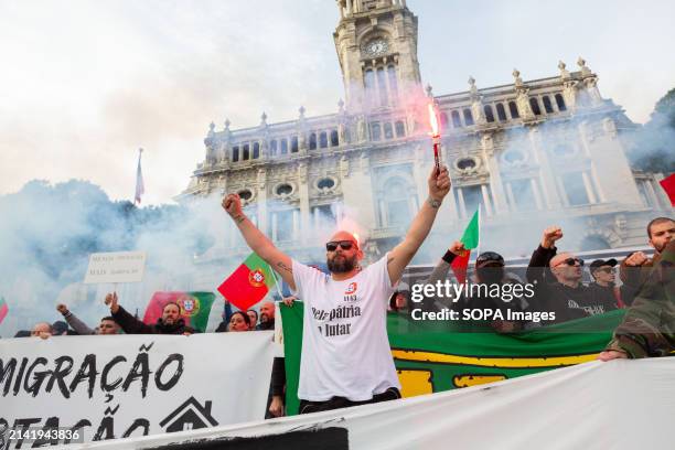An anti-immigration sympathizer holds a flare during a far-right protest in the streets of Porto Around two hundred far-right protesters demonstrated...