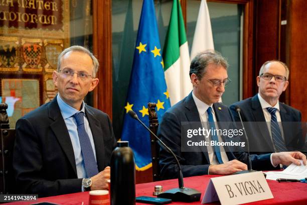 Benedetto Vigna, chief executive officer of Ferrari NV, left, Giovanni Molari, the rector of the University of Bologna, center, and Jens Hinrichsen,...