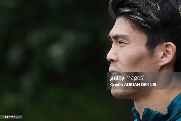 Arsenal's Japanese defender Takehiro Tomiyasu arrives for a training session on the eve of their UEFA Champions League quarter final first leg...