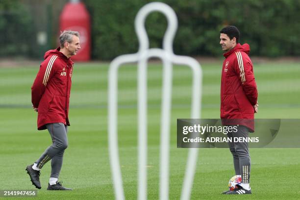 Arsenal's Dutch assistant manager Albert Stuivenberg and Arsenal's Spanish manager Mikel Arteta lead a training session on the eve of their UEFA...