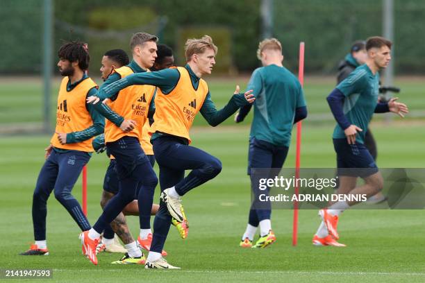 Arsenal's Norwegian midfielder Martin Odegaard takes part in a training session on the eve of their UEFA Champions League quarter final first leg...